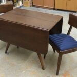 M1556 double ped table with 4 M551 side chairs, with newer fabric. Professionally redone in darker color by previous owner and still in excellent condition. 1556 and 551's
