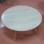 Revolving cocktail table in a natural finish made with solid Curly Maple