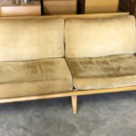 Reupholstered at some time but needs it again. Refinished in Wheat. Used with some light wear/use marks. $1750 as is. Aristocraft Davenport